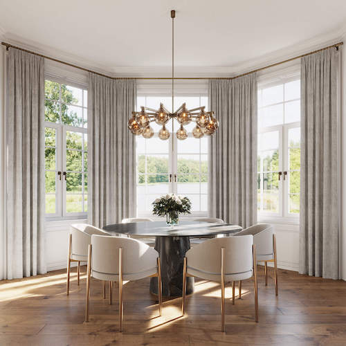 Dining table next to a bay window