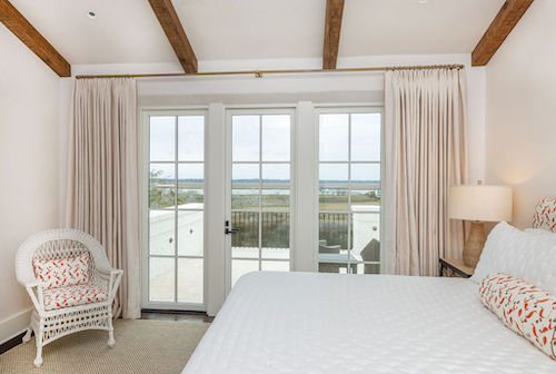 Brass french return curtain rod in a bedroom