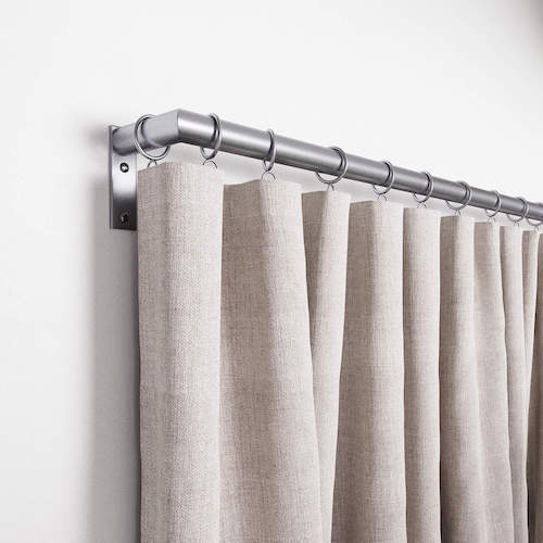 Close up of a curtain hung up on a satin nickel curtain rod